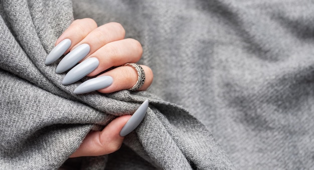 Grey manicure nails with a grey scarf