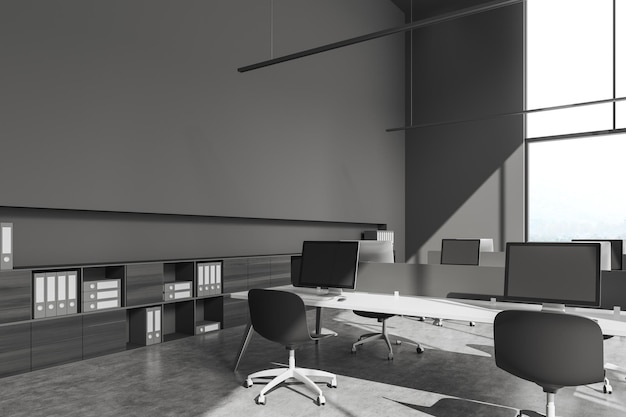 Grey office interior with pc computer and sideboard with panoramic window