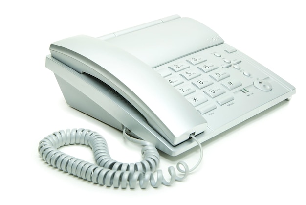 Grey office telephone on a white background