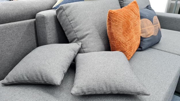 grey and orange pillows on a modern luxury sofa