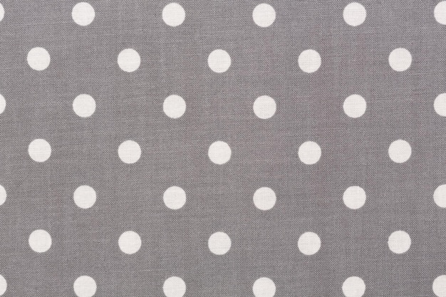 Grey polka dot fabric texture on macro background