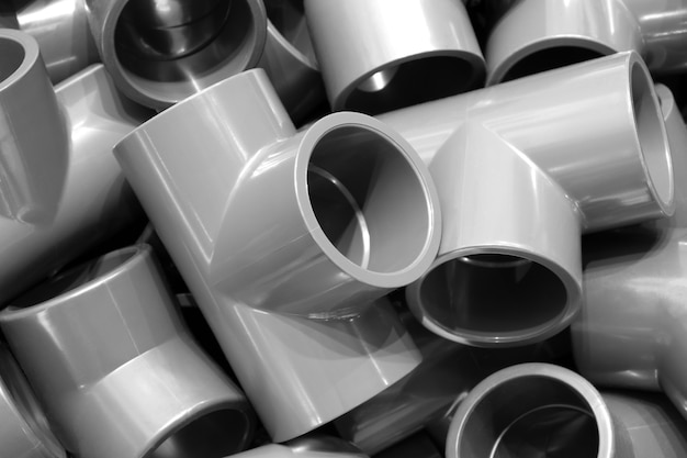 Photo grey pvc plumbing pipes corners background closeup