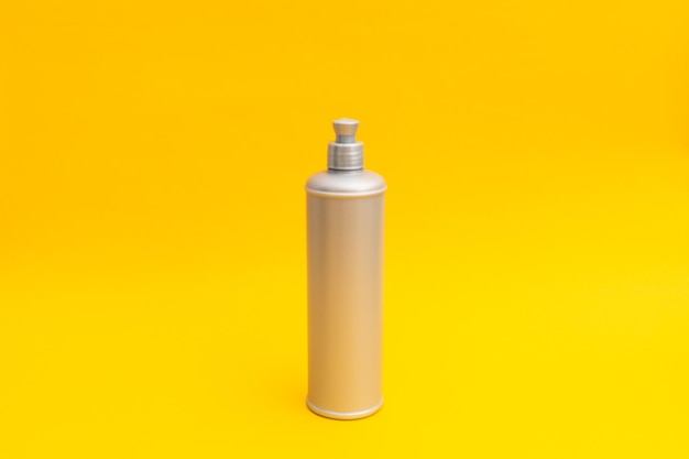 Photo grey shampoo bottle on a yellow background