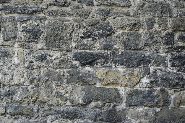 Grey stone mosaic wall background 