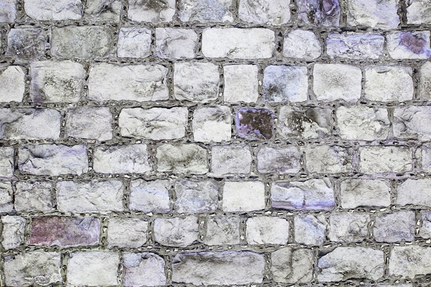 Grey and violet grunge brick wall background texture