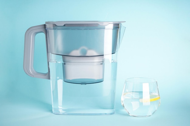 Grey Water filter jug with lemon on a blue background