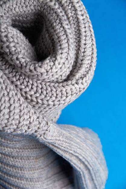 Grey wool scarf on a blue background.selective focus