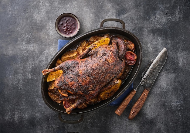 Griddleroasted goose with baked apples on gray background festive holiday recipe