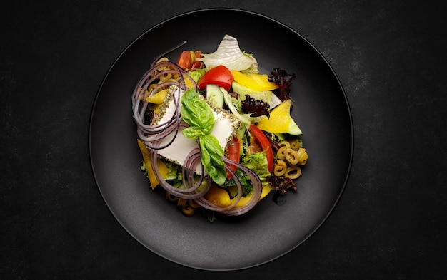 Griekse salade met olijven, kaas en groenten op een donkere achtergrond