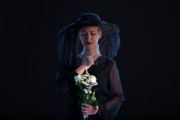 Grieving Female Dressed In All Black With Flowers On Black  Sadness Funeral Death