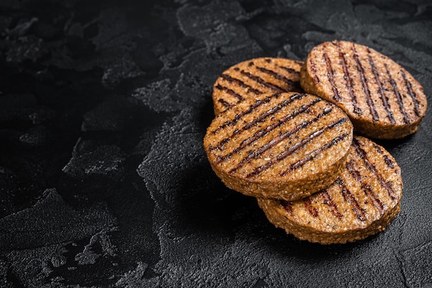 Griiled meat free patties plant based meat steak cutlets Black background Top view Copy space