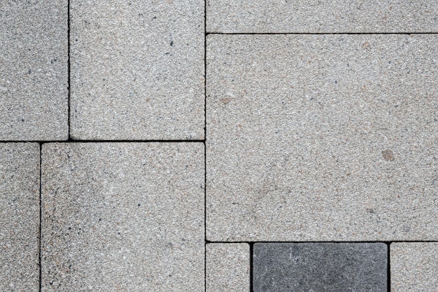 Grijze bakstenen straatweg Licht trottoir bestrating textuur