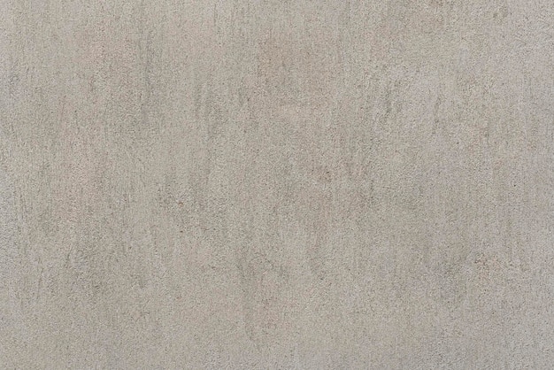 Grijze betonnen muur met kleine gaatjestextuur