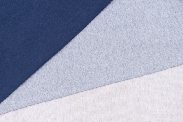 Grijze, blauwe, beige katoenen textiel, stoffenachtergrond.