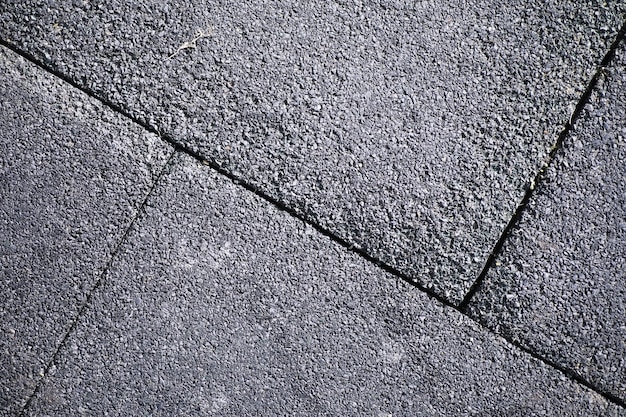 Grijze straatsteen, voetgangerspad, bestrating close-up, de textuur, bovenaanzicht. Cement baksteen vierkante stenen vloer achtergrond. Betonnen straatstenen. Bestrating platen