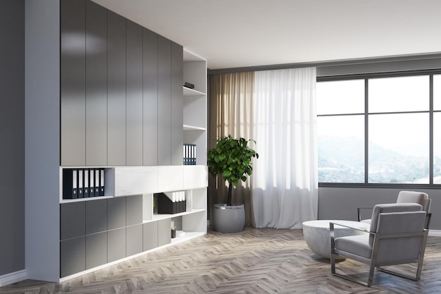 Grijze woonkamerhoek met een houten vloer, grijze boekenkasten, een witte fauteuil en een ronde salontafel. 3D-rendering mock-up