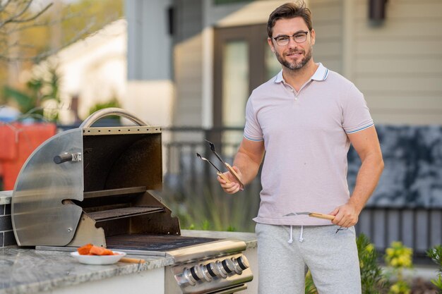 grill chef cook guy with bbq cooking tools barbecue and grill picnic and barbecue party chief cook