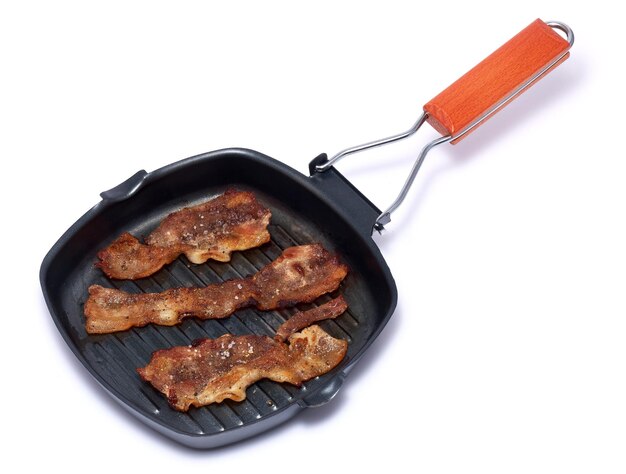 Grill frying pan with cooked bacon rashers on white background