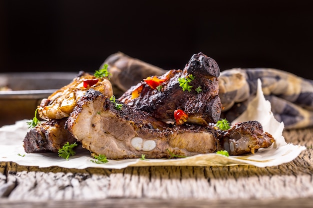 Grill pork ribs  Juicy roasted pork ribs on rustic oak table.