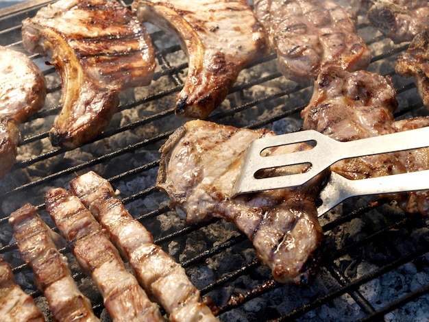 A grill with a fork on it that says " bbq " on it.