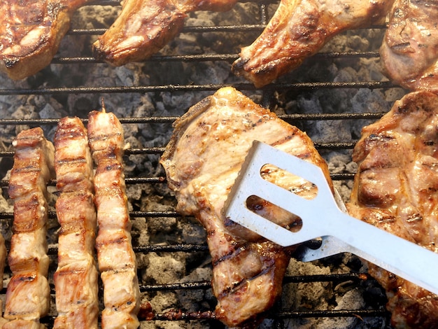 A grill with a spatula that says'pork'on it