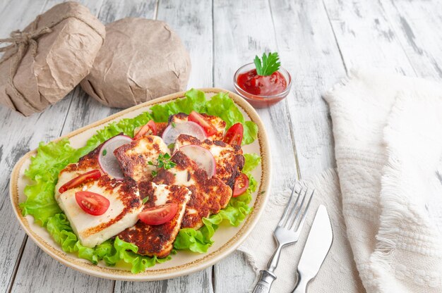 Grilled Adyghe cheese with vegetables and spices on a yellow oval plate