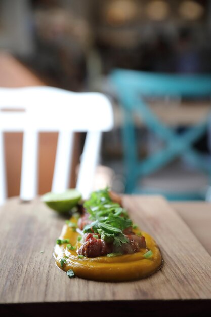 Grilled bacon with pumpkin sauce on wood background