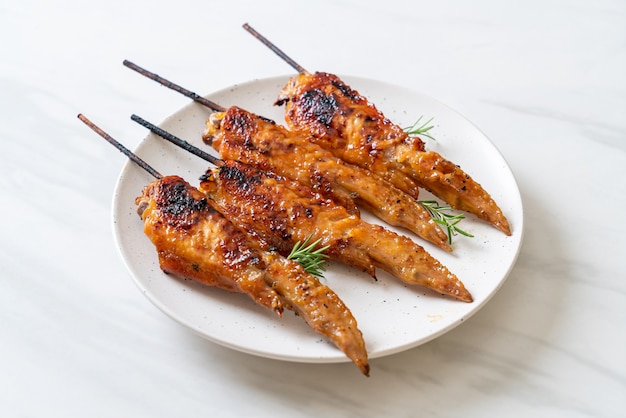 grilled or barbecue chicken wings skewer on plate