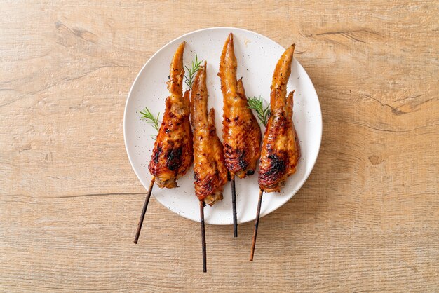 grilled or barbecue chicken wings skewer on plate