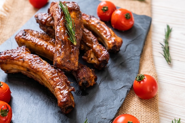 grilled barbecue ribs pork with rosemary and tomatoes