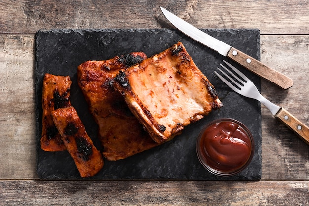 Grilled barbecue ribs on wooden table