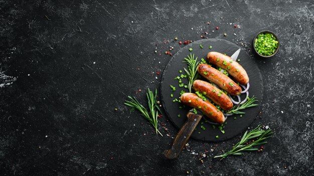 Grilled barbecue sausages with rosemary and spices Top view Free space for your text