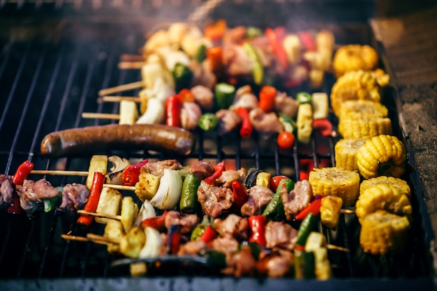 grilled barbecue skewers kebabs with vegetables on the flaming grill