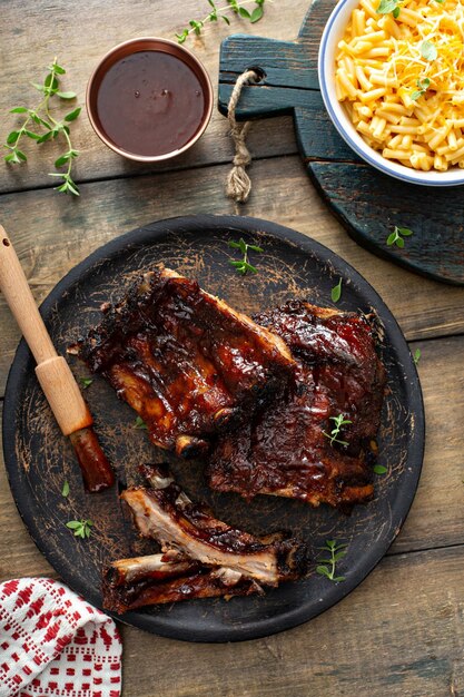 Grilled barbeque ribs with BBQ sauce and sides