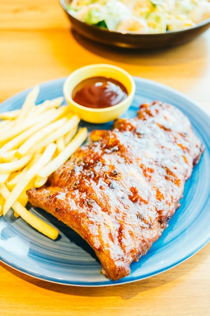 Grilled bbq or barbecue rib with french fries