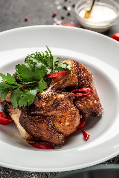 Grilled BBQ crispy chicken legs quarter with tamarind sauce and with chili peppers and herbs, Healthy fats, clean eating for weight loss