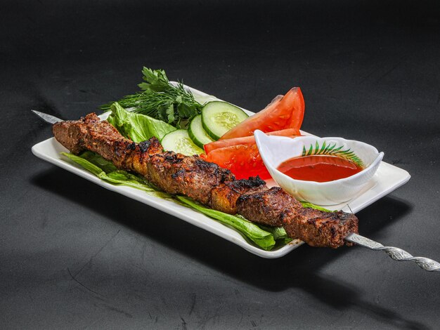 Photo grilled beef barbecue served vegetables and sauce