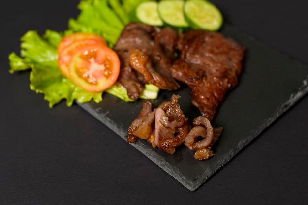 Grilled beef on plate over black background studio