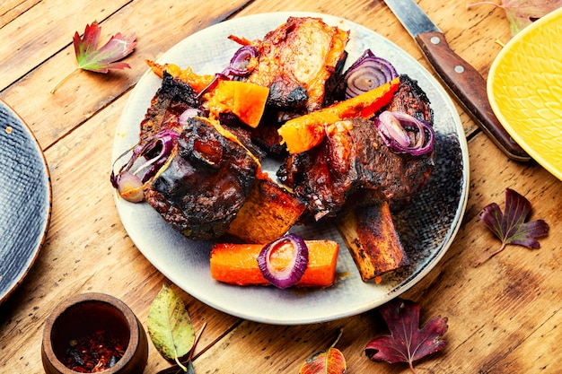 Grilled beef ribs with pumpkin.Roasted beef ribs on bone