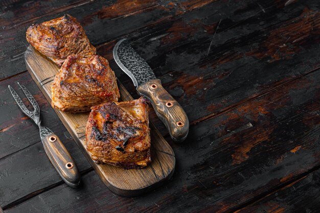 Grilled beef short rib set, on old dark  wooden table background, with copy space for text