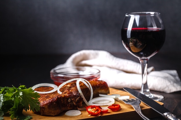 Grilled beef sliced on red plate over wood