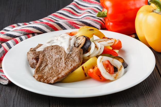 Grilled beef steak and baked vegetables