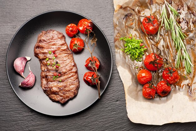 Grilled beef steak with baked vegetables and herbs