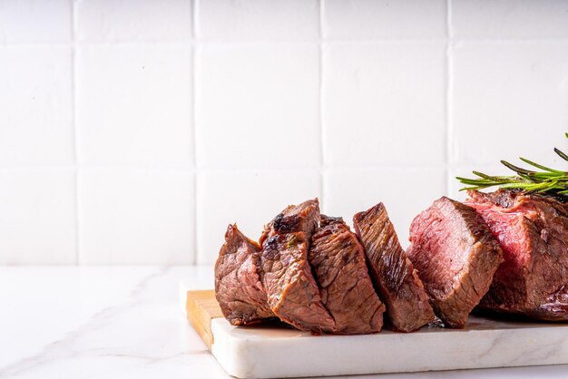 Grilled beef steak with herb and spices Portion of fried meat cuts with rosemary garlic olive oil and ketchup sauce