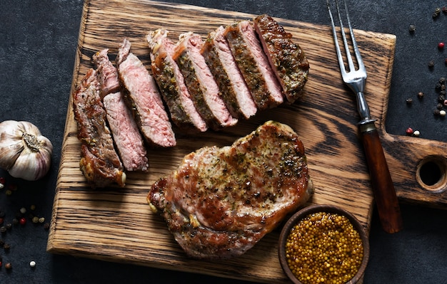 Grilled beef steak with herbs and spices. Top view with space to copy text
