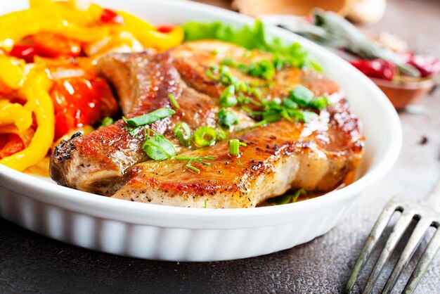 Grilled beef steak with rosemary in white plate