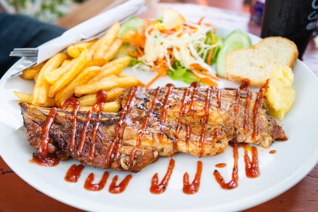 Grilled beef steak with salad on a plate