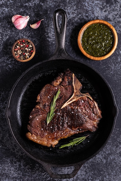 Grilled beef steak with spices in a frying pan