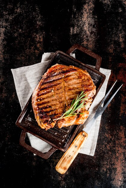 Grilled beef steak with spices on grill pan board