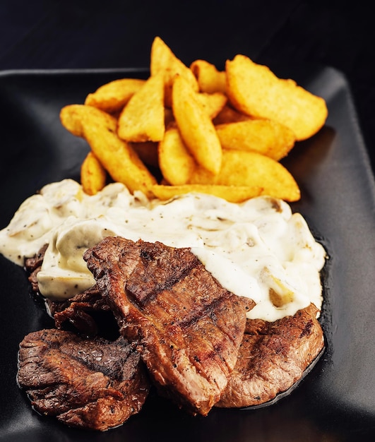 Grilled Beef Steaks with Mushroom Sauce and french fries